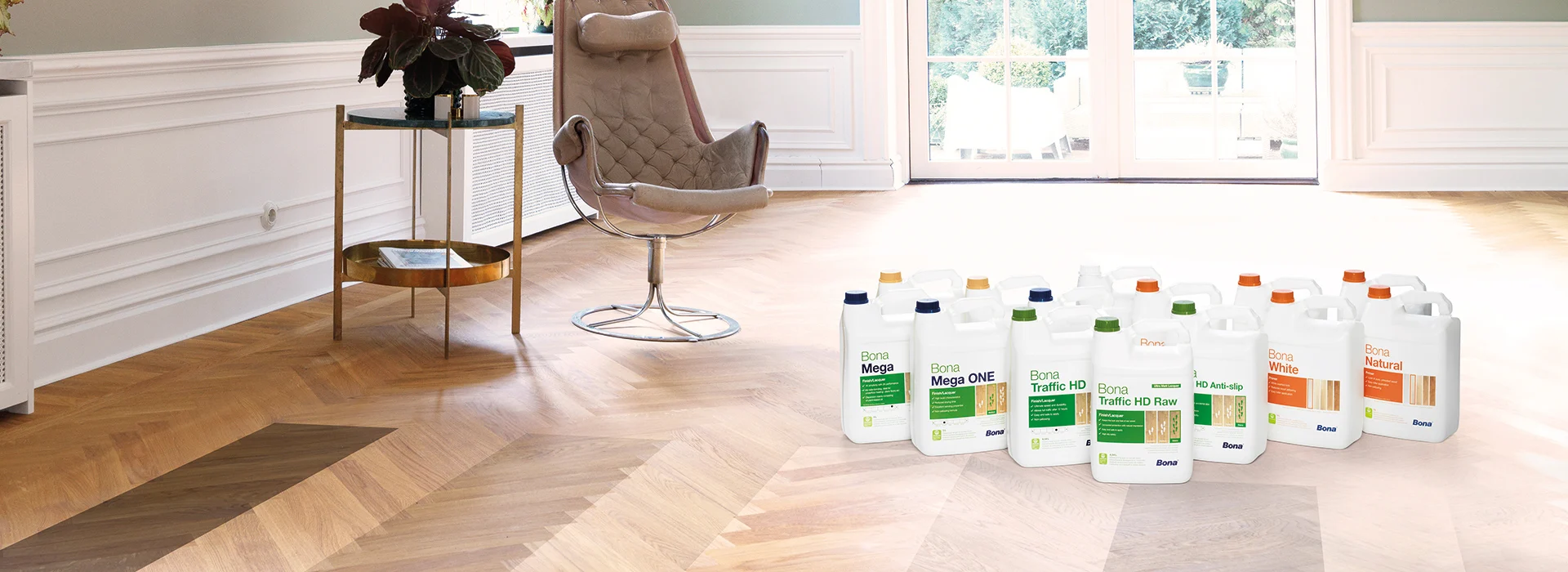Selection of finishing products used for Parquet Floor Repairs in West Kensington, displayed on a restored oak herringbone parquet floor.