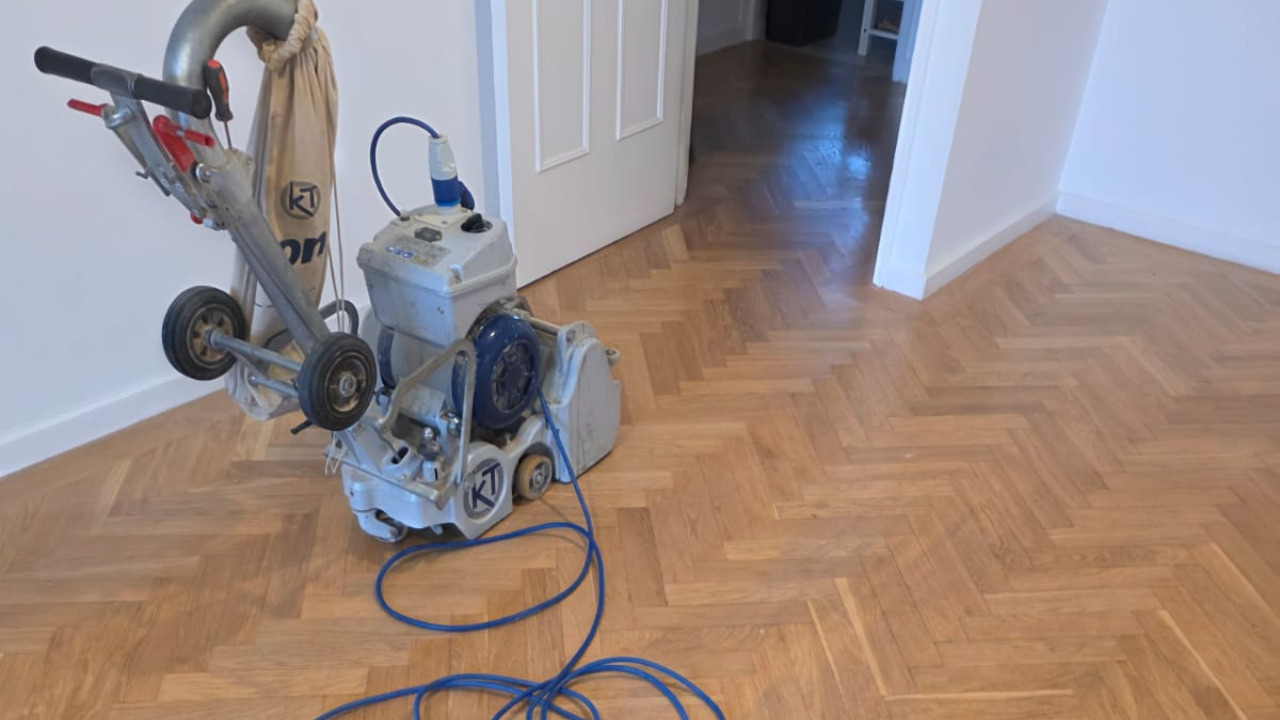 Parquet Floor Sanding in West Kensington – oak herringbone parquet room with a professional sanding machine set up ready for dust-free restoration.