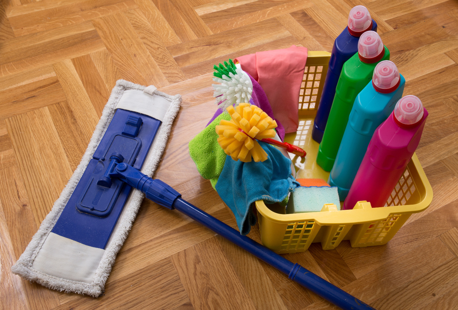 Parquet Floor Sanding in West Kensington – oak mosaic parquet floor with cleaning kit and mop laid out for aftercare of the restored wood surface.